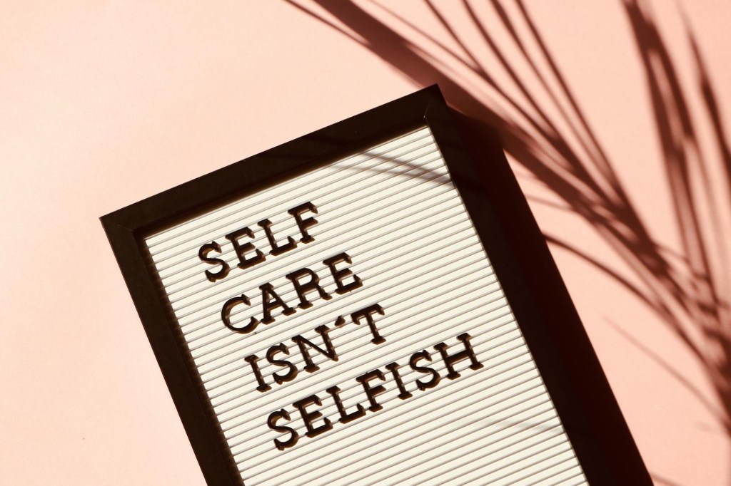 black and white editable pin board with letters spelling out "self care isn't selfish"